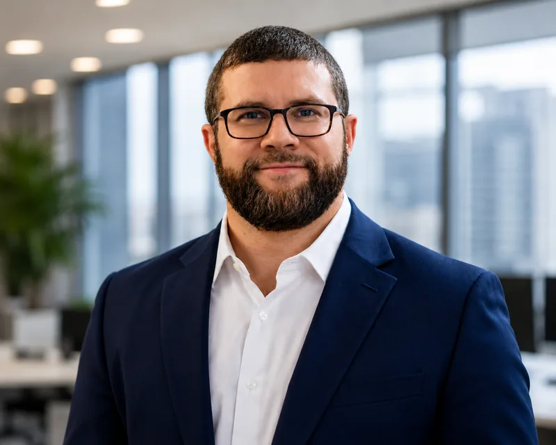 Professional headshot of Joshua Reh, Principal and Co-Founder of Cijara Group, facing the camera in business attire against a neutral studio background